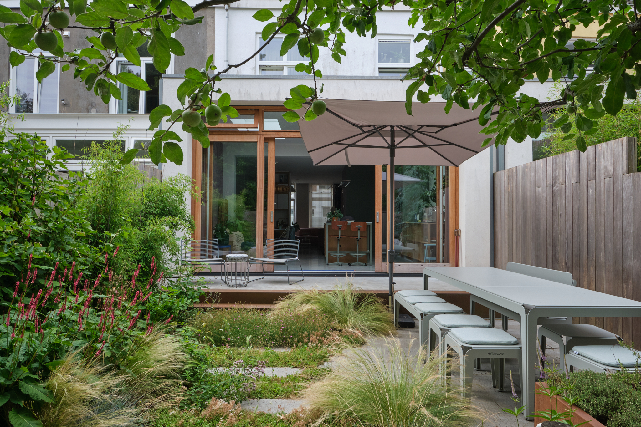 Complete garden overview with glass doors and modern furniture
